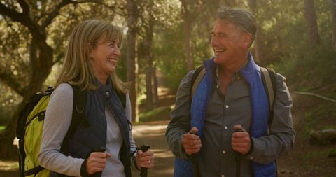 Happy Senior Couple Hiking with Backpacks in Forest - Download Free Stock Images Pikwizard.com