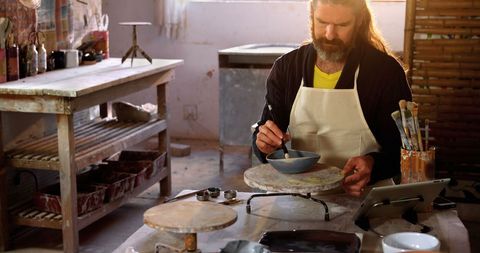 Male Artisan Painting Ceramic Bowl in Pottery Workshop - Download Free Stock Images Pikwizard.com