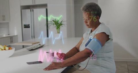 Senior woman monitoring vitals at kitchen island with holographic telehealth display