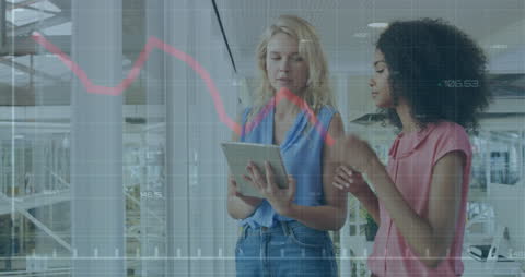 Diverse Businesswomen Analyzing Financial Data on Tablet