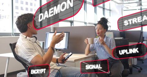 Colleagues discussing cybersecurity and network terms over coffee in bright open-plan office