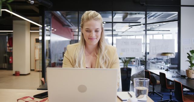 Smiling Professional Woman Remote Working in Modern Office - Download Free Stock Images Pikwizard.com