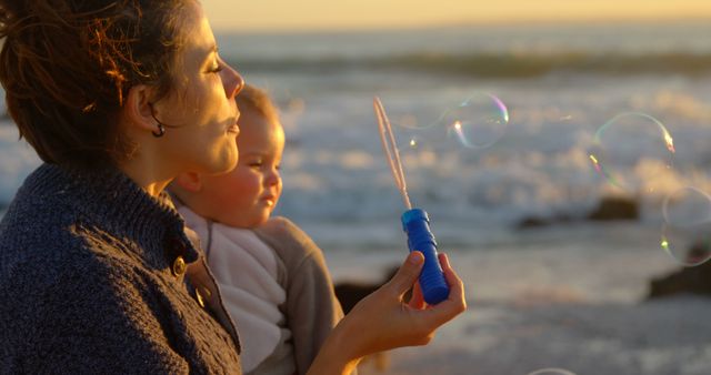 Mother and Baby Blowing Bubbles at Sunset Beach - Download Free Stock Images Pikwizard.com