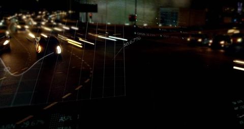 Urban night traffic leaving light trails with data visualization overlay and gridlines