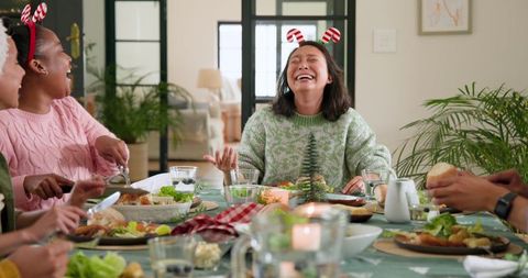 Mixed Heritage Friends Sharing Festive Dinner with Laughter and Joy