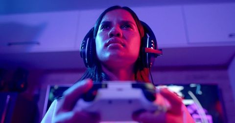 Focused Teen Gamer Engaged in Virtual World with Headset and Controller