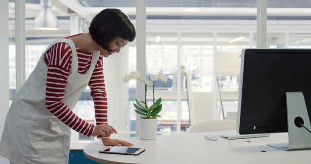 Young Asian Woman Using Tablet in Modern Office Environment - Download Free Stock Images Pikwizard.com