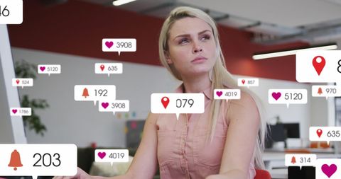 Businesswoman monitoring social media notifications in modern office