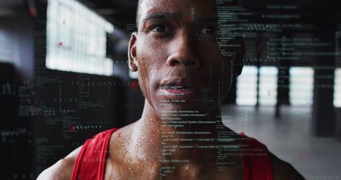 African american athlete training and showing code overlay in industrial warehouse gym