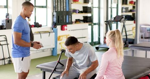 Rehabilitation Therapy with a Disabled Man in Gym Setting