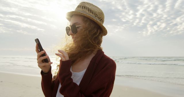 Young Woman Using Smartphone at Beach on Sunny Day - Download Free Stock Images Pikwizard.com