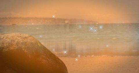 Ethereal Beachscape with Mossy Boulder and Sparking Ocean