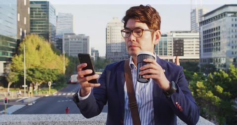 Urban Professional Checking Smartphone with Coffee on Balcony
