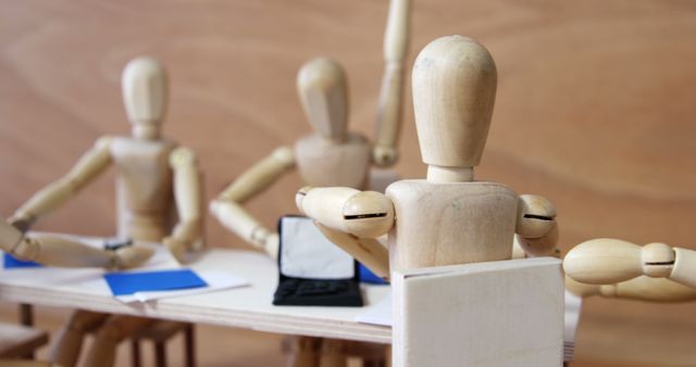 Wooden Art Mannequins Having Business Meeting with Laptops - Download Free Stock Images Pikwizard.com