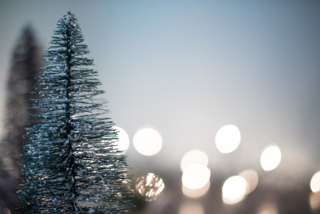 Capture essence of festive season with close-up of Christmas trees and blurred holiday lights in background. Perfect for greeting cards, holiday marketing campaigns, seasonal blog posts, and social media content focused on Christmas and winter celebrations.
