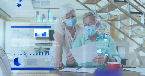 Senior Couple Analyzing Business Data while Staying Safe at Home