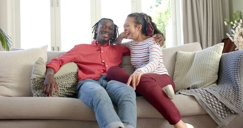 Happy Diverse Couple Relaxing on Cozy Couch at Home - Download Free Stock Images Pikwizard.com