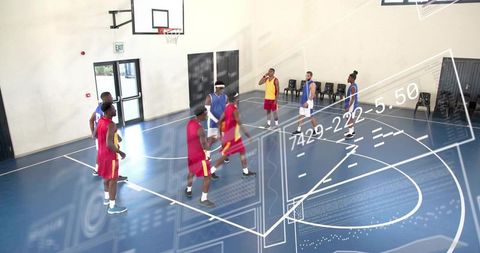 Eight players scrimmaging on indoor basketball court with augmented analytics overlay