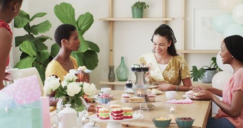Diverse friends enjoying a celebration with cupcakes and laughter