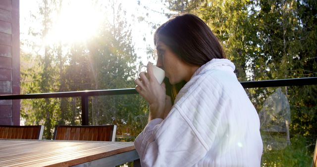 Woman Relaxing on Balcony While Drinking Coffee in Morning Sun - Download Free Stock Images Pikwizard.com