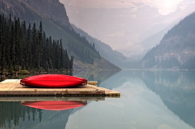Red Canoe on Tranquil Mountain Lake with Reflection - Download Free Stock Photos Pikwizard.com