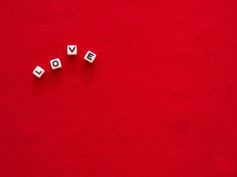 Alphabet blocks spelling love on red background
