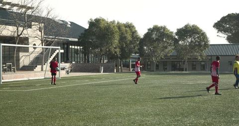Soccer Team Celebrating on Sunny School Field
