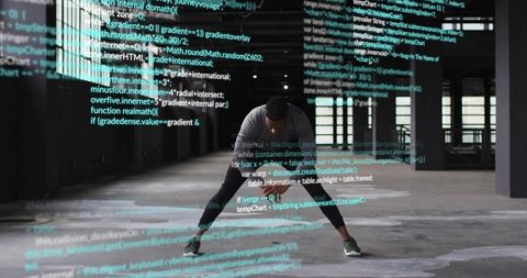 Athlete stretching in industrial warehouse with projected code overlay for tech fitness