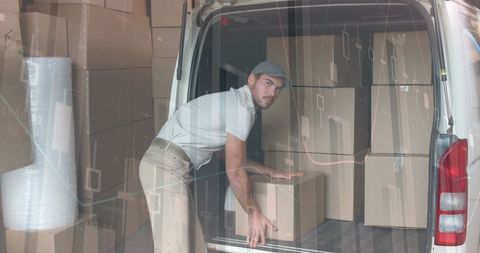 Delivery Man Loading Packages with Financial Data Overlay - Download Free Stock Images Pikwizard.com