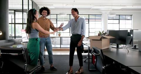 Diverse Colleagues Unpacking and Collaborating in Modern Workspace