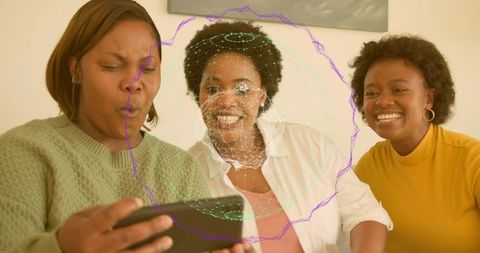 Three women laughing on sofa using smartphone with digital face mesh overlay