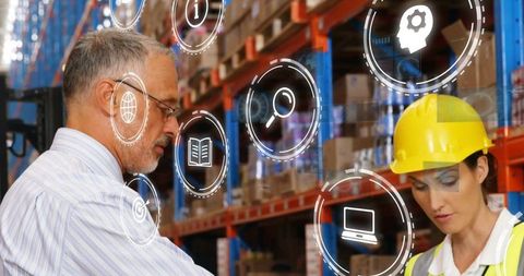 Engineer with supervisor analyzing warehouse inventory using digital tools