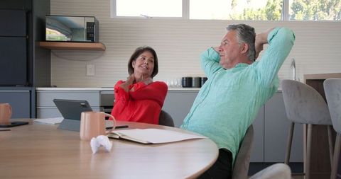 Senior Couple Engaging in Friendly Conversation in Modern Kitchen