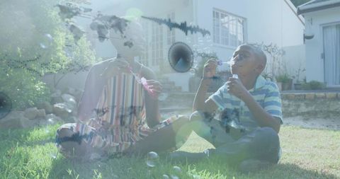 Woman and Boy Blowing Bubbles on Sunny Front Lawn with Lens Flare Overlay
