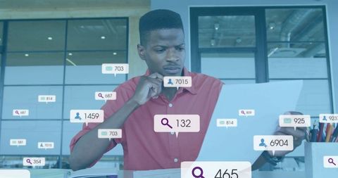 Data analyst in modern office analyzing information on laptop