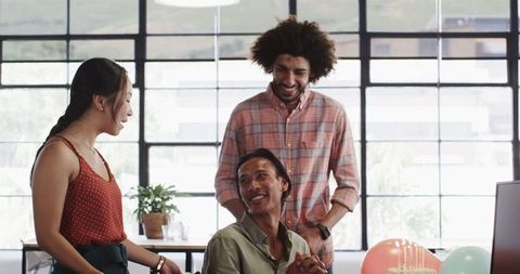 Diverse Colleagues Surprise Coworker with Birthday Celebration at Office