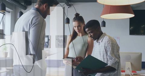 Diverse team collaborating with technology in modern workplace