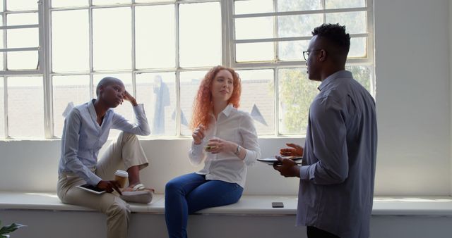 Diverse Colleagues Having Casual Office Discussion by Window - Download Free Stock Images Pikwizard.com