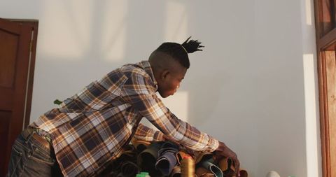 Craftsman selecting leather materials in handcrafted workshop