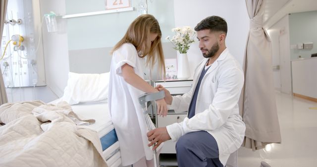 Male Doctor Assisting Young Girl in Hospital Room - Download Free Stock Images Pikwizard.com