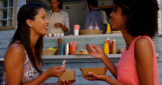 Friends Enjoying Street Food at Outdoor Festival - Download Free Stock Images Pikwizard.com