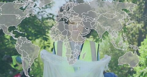 Volunteers in Safety Vests Picking Up Litter in Park With World Map Overlay