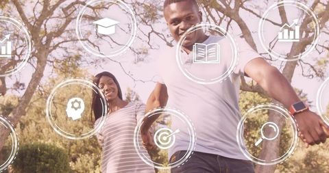 Smiling young couple walking in sunlit park with floating education, growth and tech icons