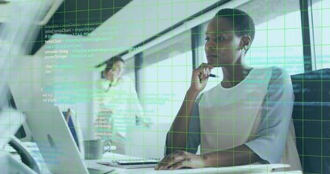 Overlaid Code with Businesswoman in Modern Office Environment