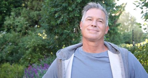 Contemplative Middle-Aged Man in Lush Backyard Environment