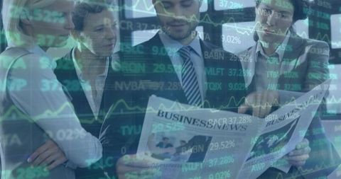 Business professionals analyzing market data while reading business news