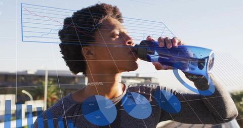 Athlete drinking from reusable bottle on rooftop with fitness data overlays, charts