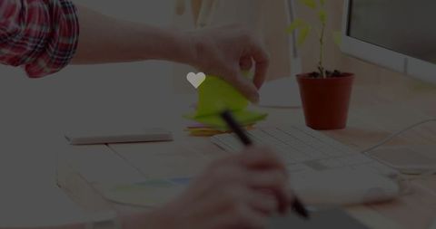 Office desk with sticky notes and digital art workspace