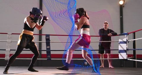 Female boxers sparring in gym ring with coach watching and digital motion trail overlay