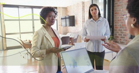Three professionals collaborating in modern office discussing project strategy and analytics